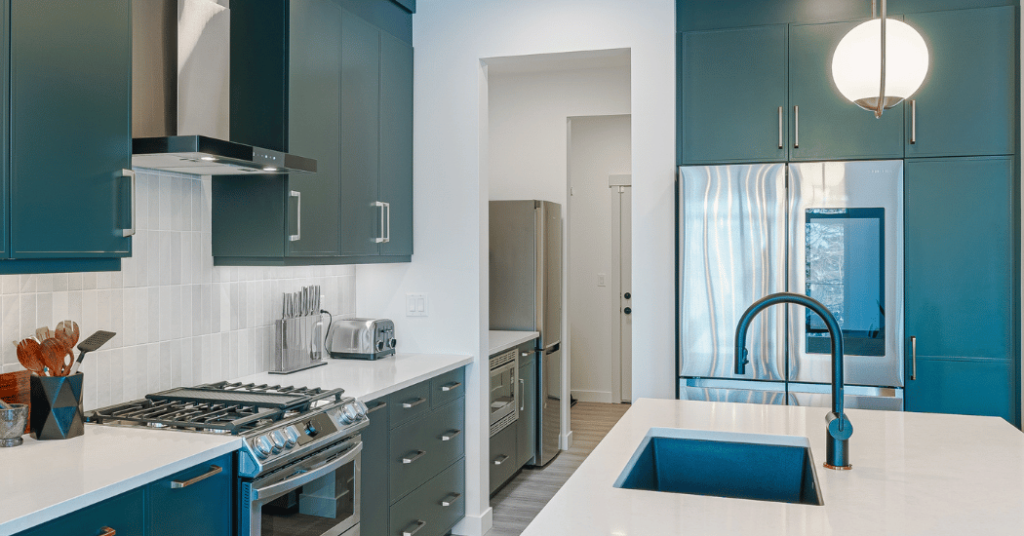 A photo of a modern kitchen highlighting with a walkthrough pantry area with a fridge and cabinets inside.