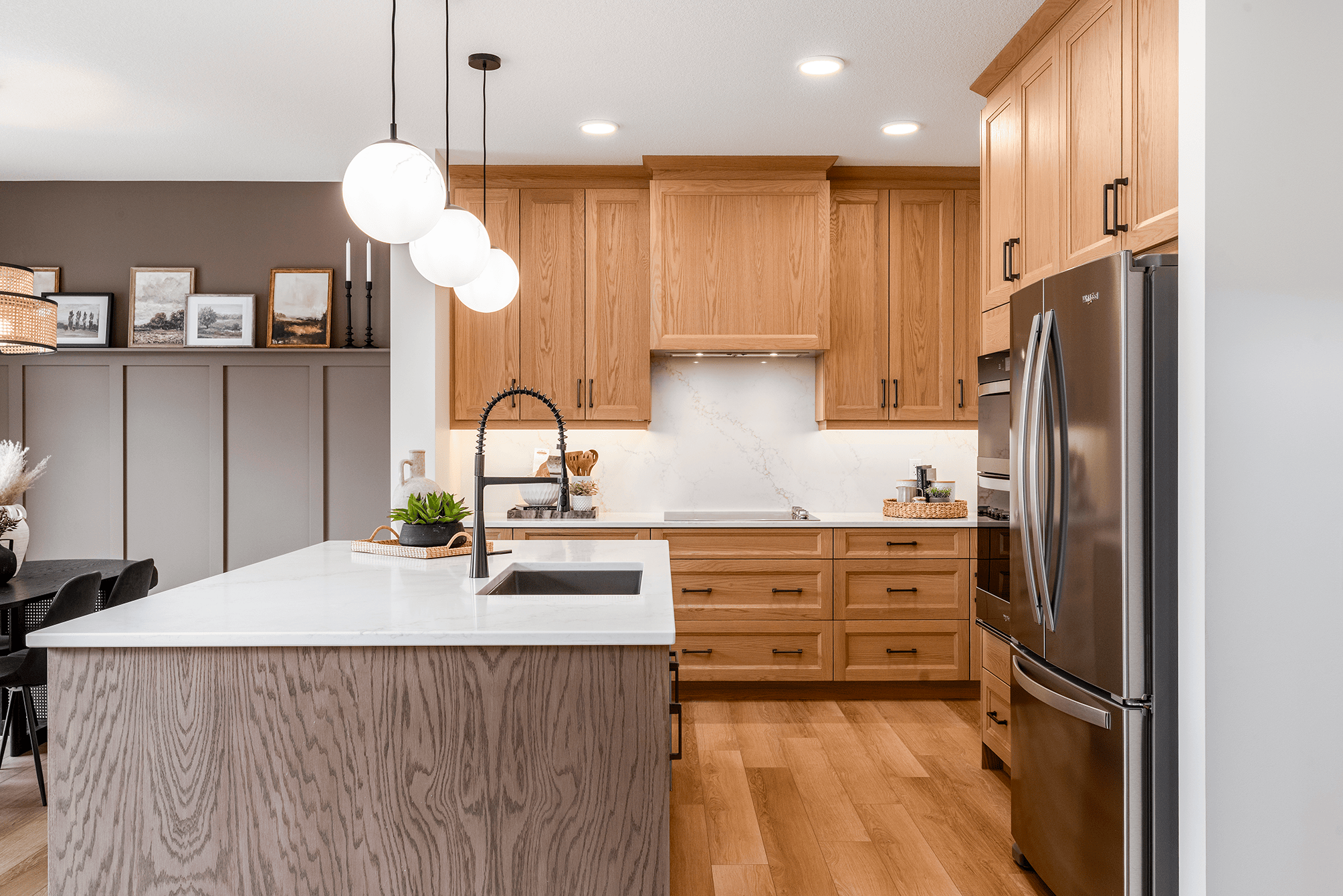Light contemporary kitchen perimeter cabinetry in Oak Butterscotch and island in Oak Saffron, both with Arizona five-piece recessed-panel doors by Superior Cabinets