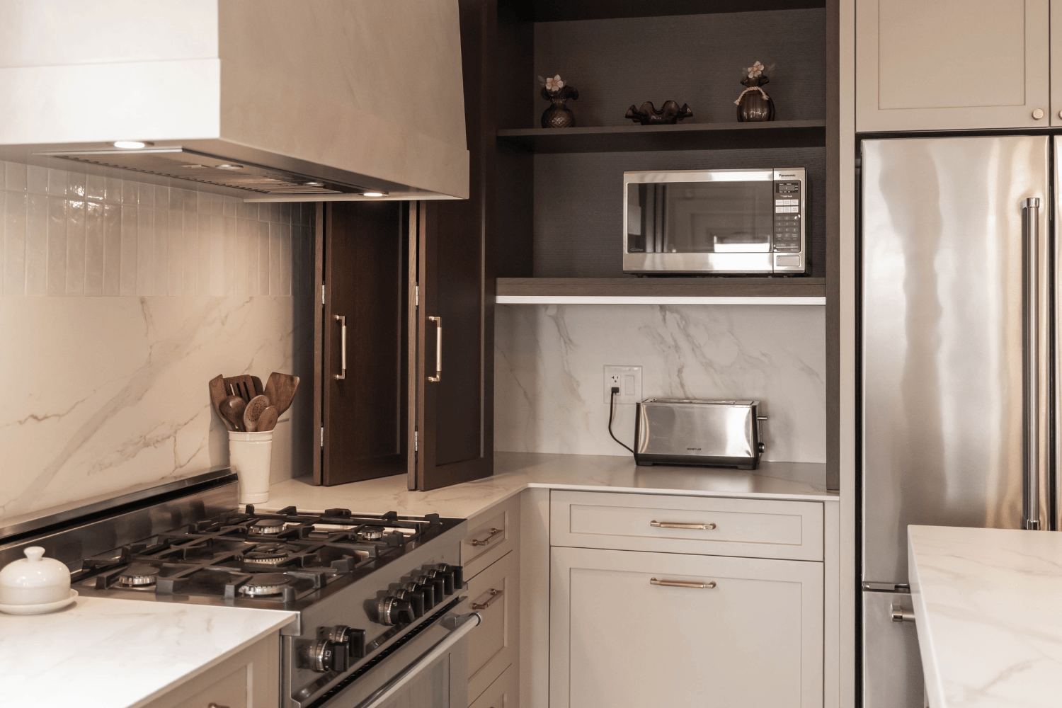 Kitchen with a Hettich folding door system appliance garage (Doors Open). Featuring rift cut white oak cabinetry, English Tea stain by Superior Cabinets.
